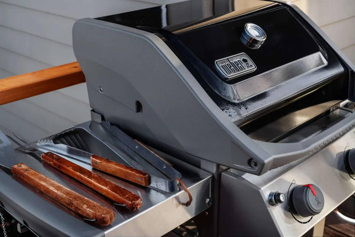 A close-up view of the deck’s grilling area with a grill and grilling tools, evoking the casual, welcoming atmosphere perfect for relaxed evenings or pet-friendly outdoor enjoyment.